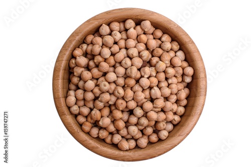 Chickpeas in a wooden plate on a cut isolated white background