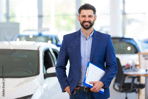 Car dealer in showroom
