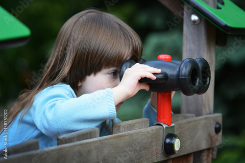 Little girl looking through binoculars