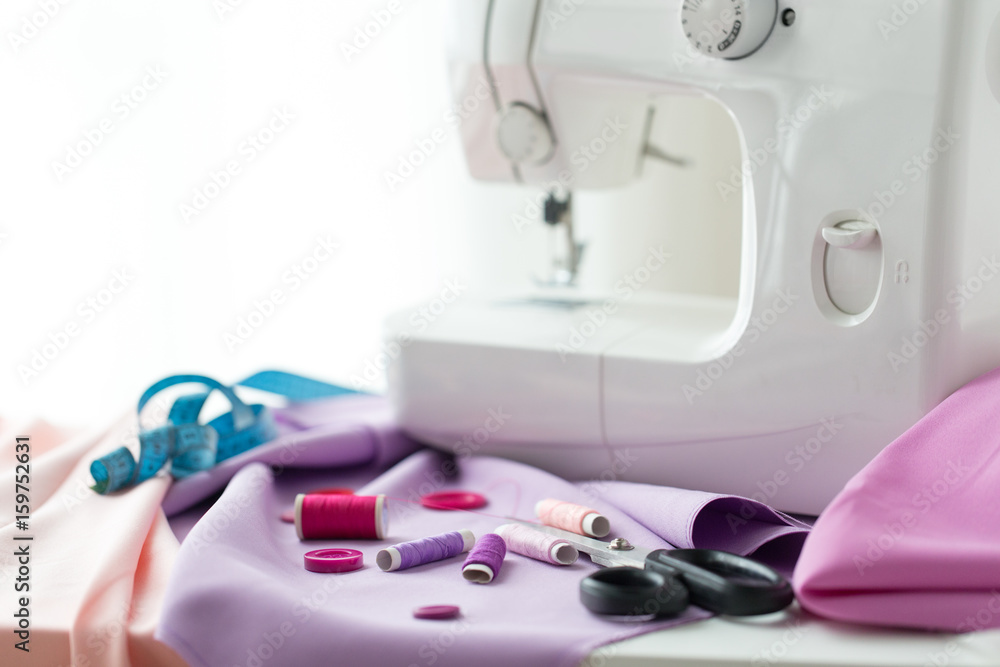sewing machine, scissors, buttons and fabric