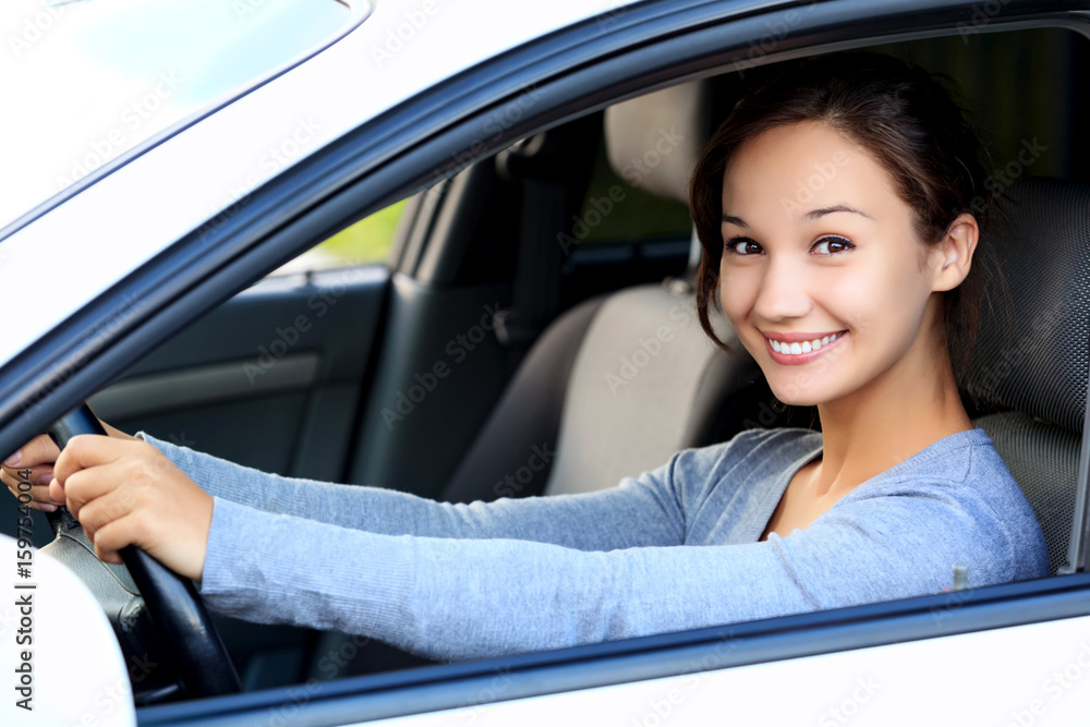 Beautiful woman driver smiling to you from her car Beautiful woman driver smiling to you from her car
