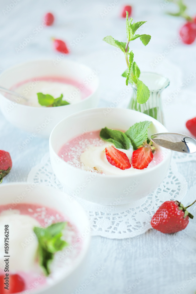 Cold creamy strawberry soup with a scoop of ice cream and mint Cold creamy strawberry soup with a scoop of ice cream and mint