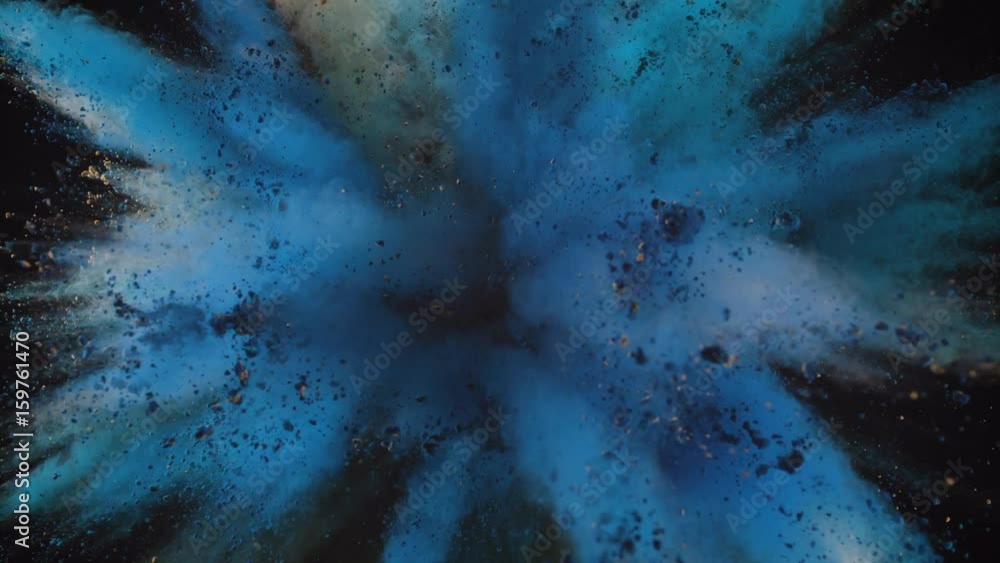 Colorful powder/particles fly after being exploded against black ...