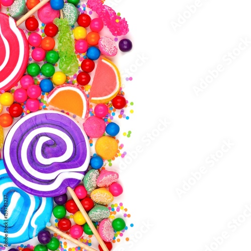 Side border of an assortment of colorful candies against a white background