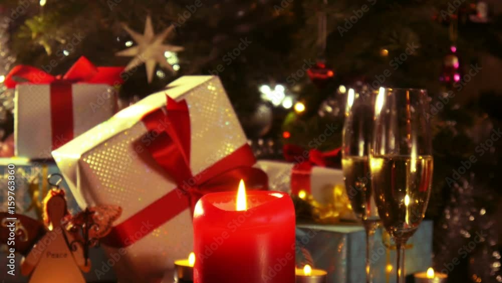 Christmas gifts and champagne glasses with burning candle - 4 k Christmas gifts and champagne glasses with burning candle - 4 k