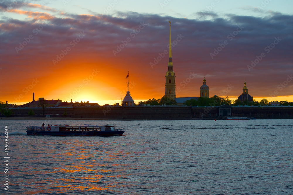 The boat trip on the sunset at the walls of the Peter and Paul fortress. Saint-Petersburg