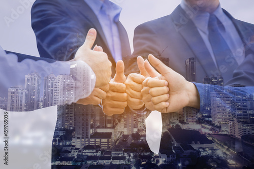 Double exposure of businesspeople shaking hand together with agreemant concept. photo