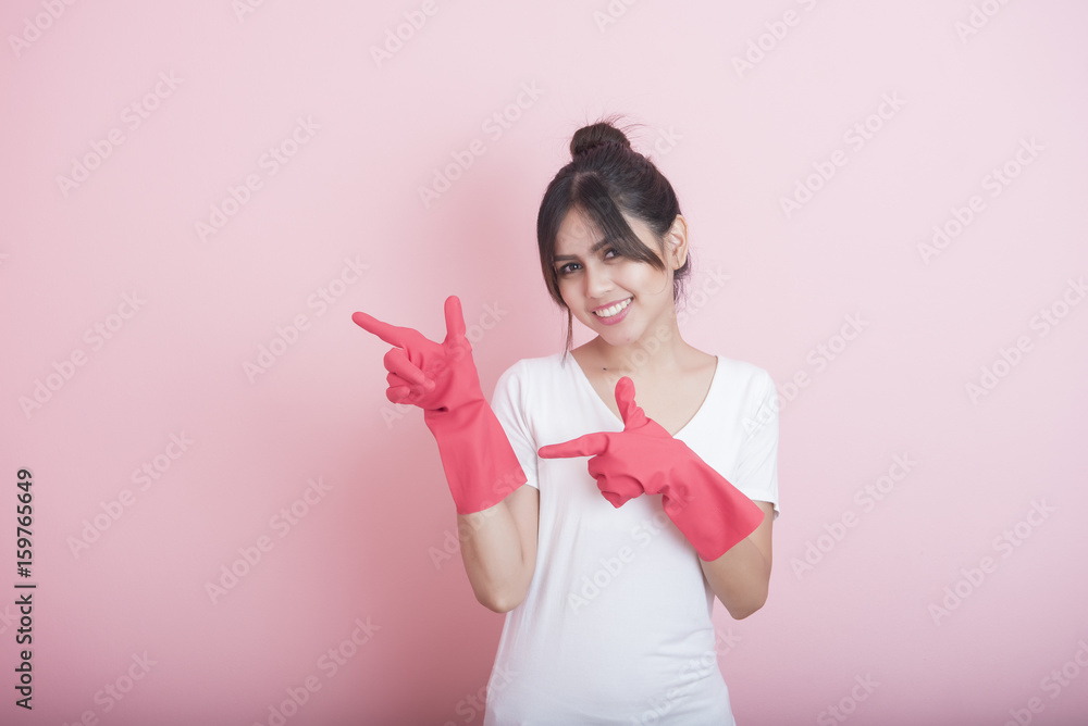 Beautiful asian housewife smiling on pink background Beautiful asian housewife smiling on pink background