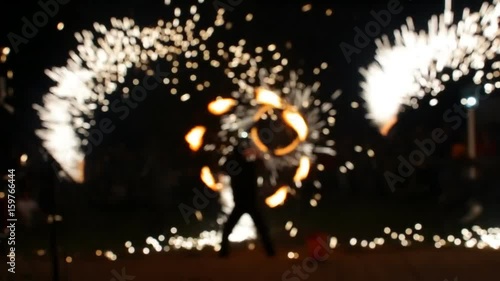 Blurred View, Fire Show. Men make fire circles. Blurry background