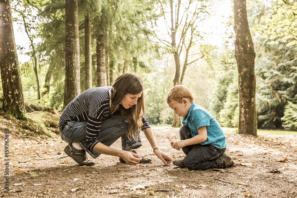 Mother playing with son (2-3) in park Mother playing with son (2-3) in park