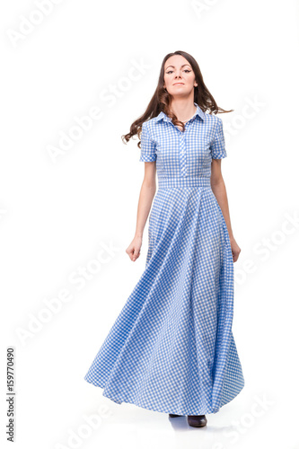 Beautiful girl in a blue cage dress on a white background