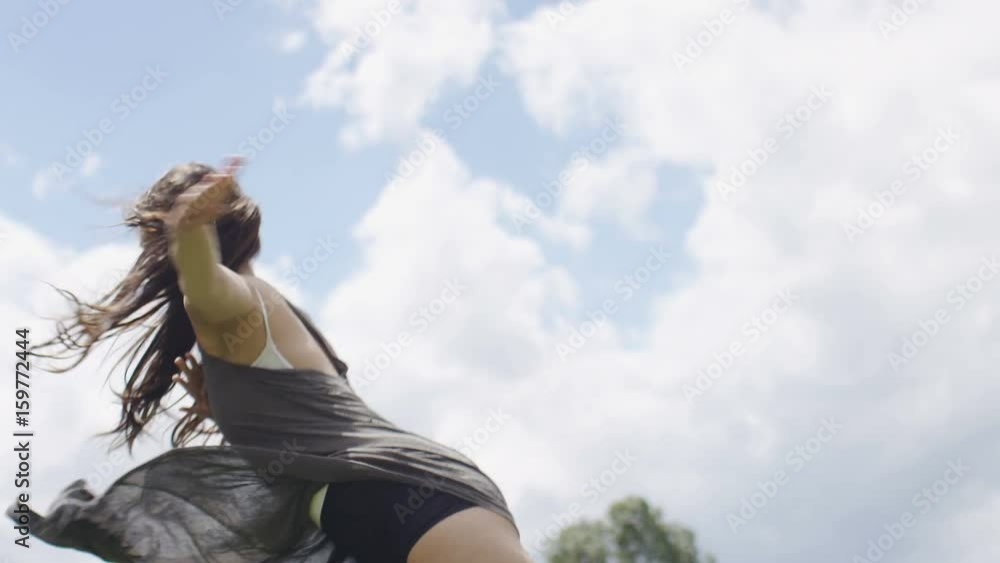 Beautiful young woman dancing in nature, in slow motion Beautiful young woman dancing in nature, in slow motion