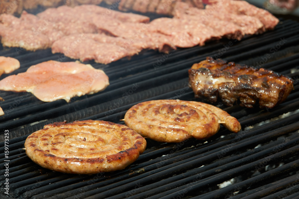 Sausages and meat on the grill. Sausages and meat on the grill.