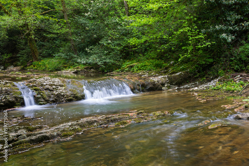 Mountain river with small waterfall