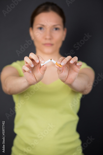 woman breaking cigarette decided to quit smoking