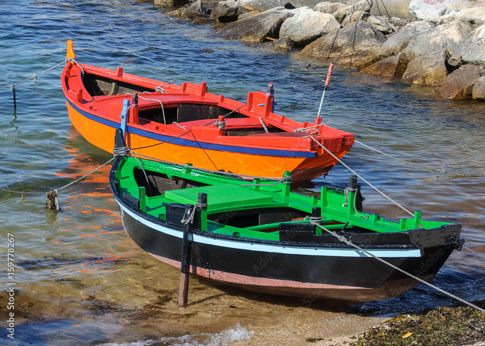 wooden fishing boat moored near the shore
