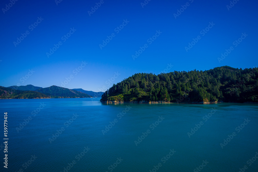 Beautiful landscape of mountain with gorgeous blue sky in a sunny day seen from ferry from north island to south island, in New Zealand