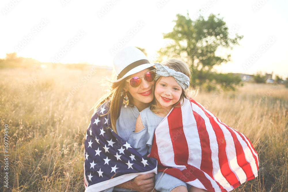 © MeganBetteridge - Patriotic mother and daughter with American flag