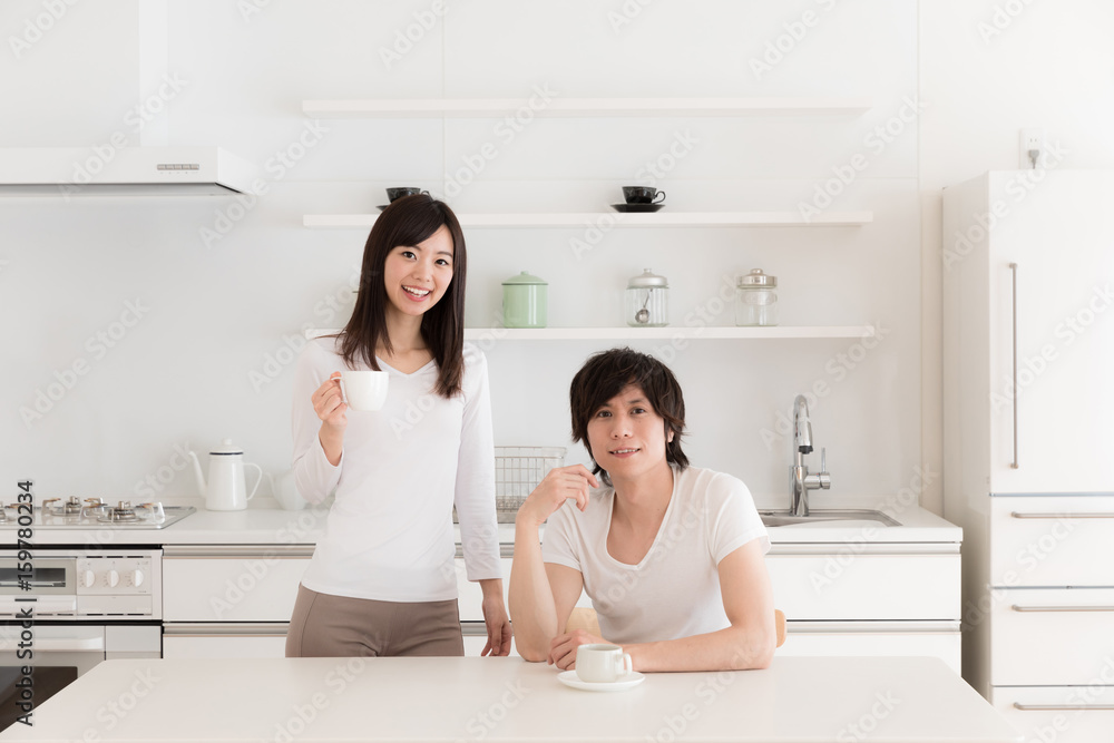 young asian couple relaxing in kitchen young asian couple relaxing in kitchen