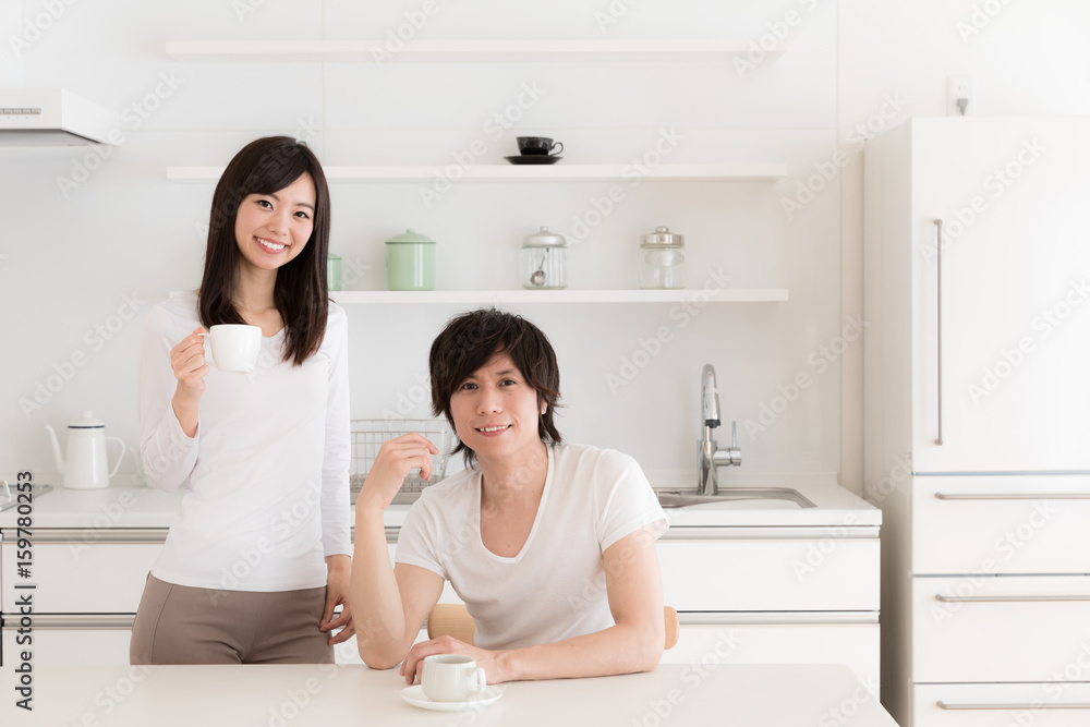 young asian couple relaxing in kitchen young asian couple relaxing in kitchen