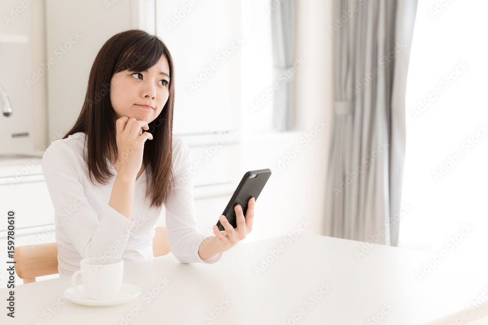 young asian woman relaxing in kitchen young asian woman relaxing in kitchen