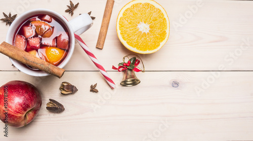 New Year's and Christmas decoration with ingredients for preparation mulled wine, cinnamon and cloves, lined Border on a white wooden rustic background, space for text, top view