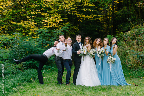Guests at the wedding send an air kiss to the camera in nature in summer © Vladimir