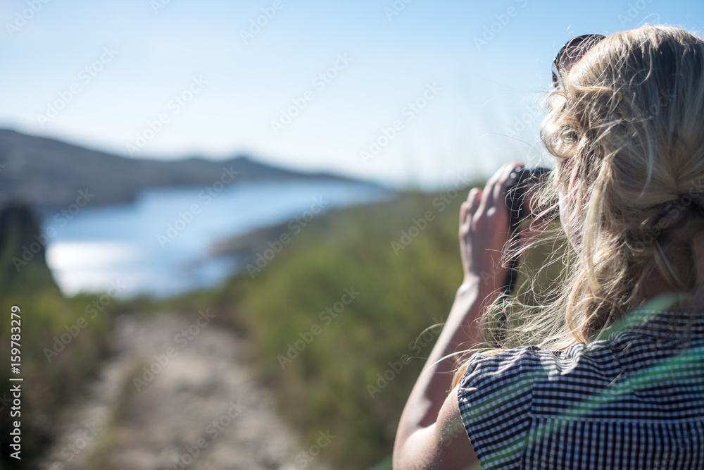 Young woman with camera, Symbol photographing woman, Emotive pictures of beautiful women on vacation, Detail of young blonde woman with camera in wild Young woman with camera, Symbol photographing woman, Emotive pictures of beautiful women on vacation, Detail of young blonde woman with camera in wild
