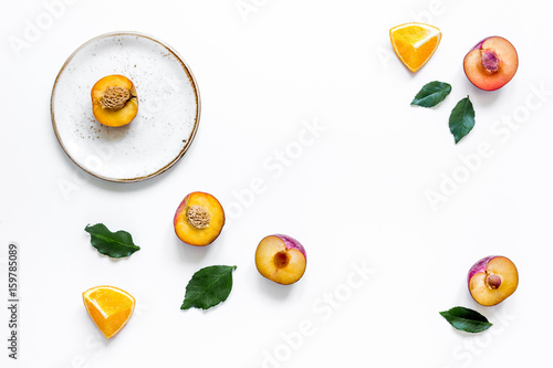 woman summer breackfast with orange and peach fruits on plates on white background flat lay mockup photo