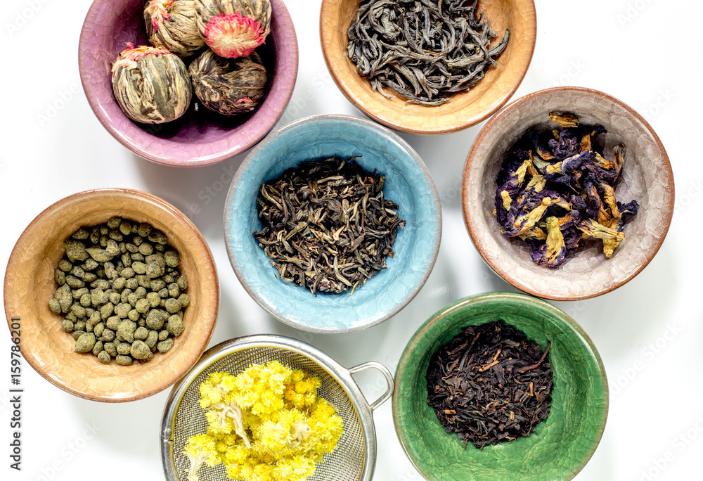 Tea-party with different herbal tea on white desk background flat lay pattern Tea-party with different herbal tea on white desk background flat lay pattern