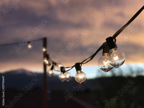 String lights during mountain sunset. 