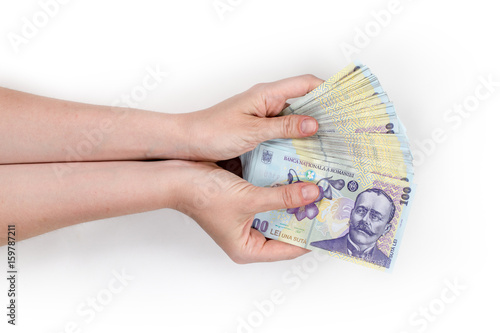 Woman's hand holding money isolated on white background. Romanian banknotes 100 RON. photo