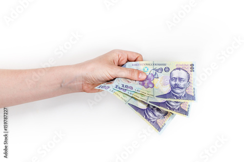 Woman's hand holding money isolated on white background. Romanian banknotes 100 RON.