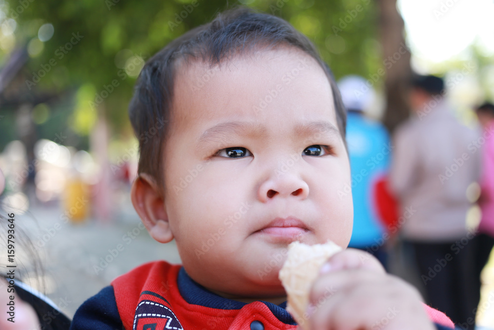 Asian boy faces eating sweets with pleasure. Asian boy faces eating sweets with pleasure.