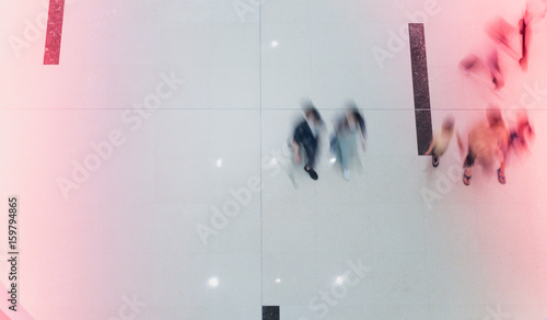 business people walking in shopping mall blur motion