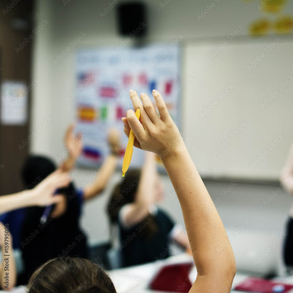 Group of student learning arms raised Group of student learning arms raised