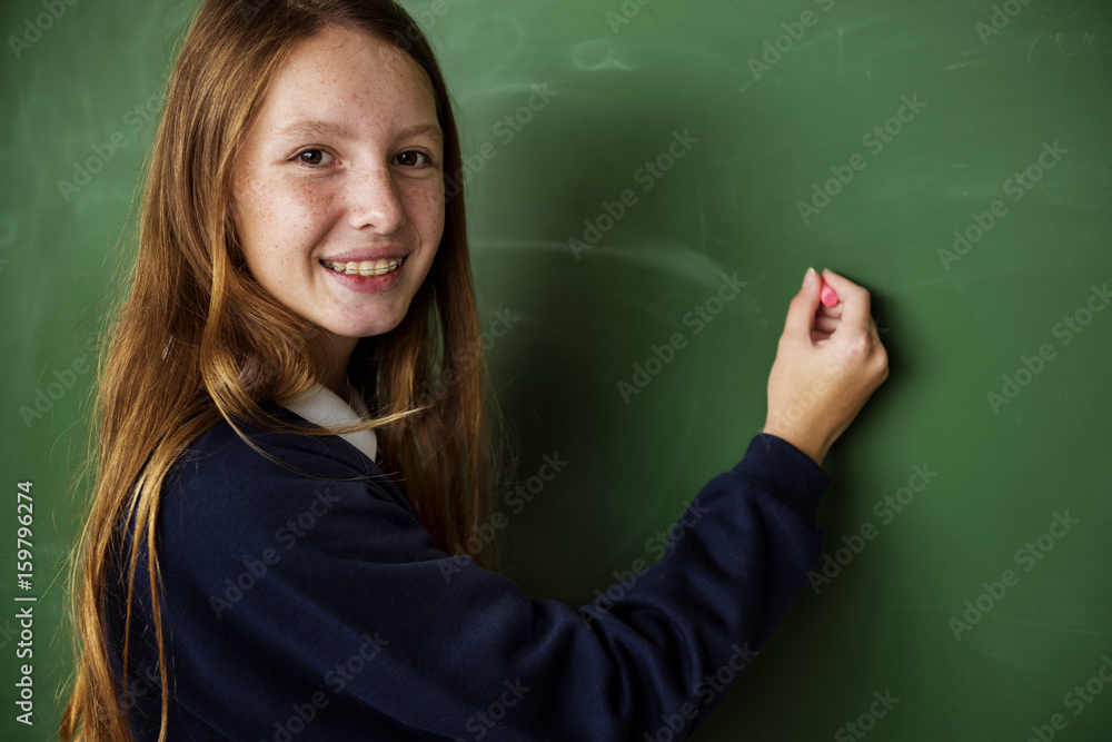 Girl student writing on a blackboard Girl student writing on a blackboard
