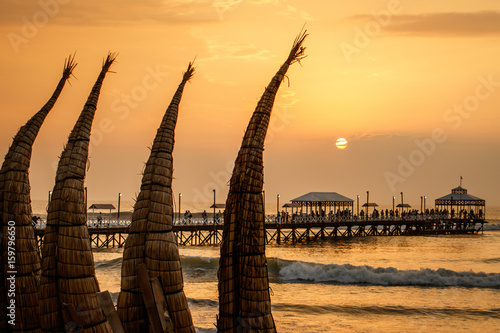 The sunset with traditional boat craft at Huanchaco town, Peru