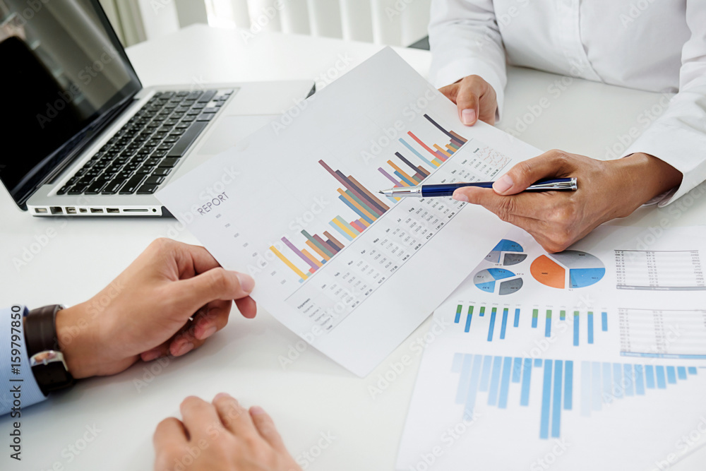 Business concept. Business people discussing the charts and graphs showing the results of their successful teamwork. Business concept. Business people discussing the charts and graphs showing the results of their successful teamwork.