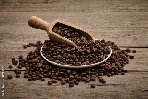 Spoon of Coffee beans with wooden table