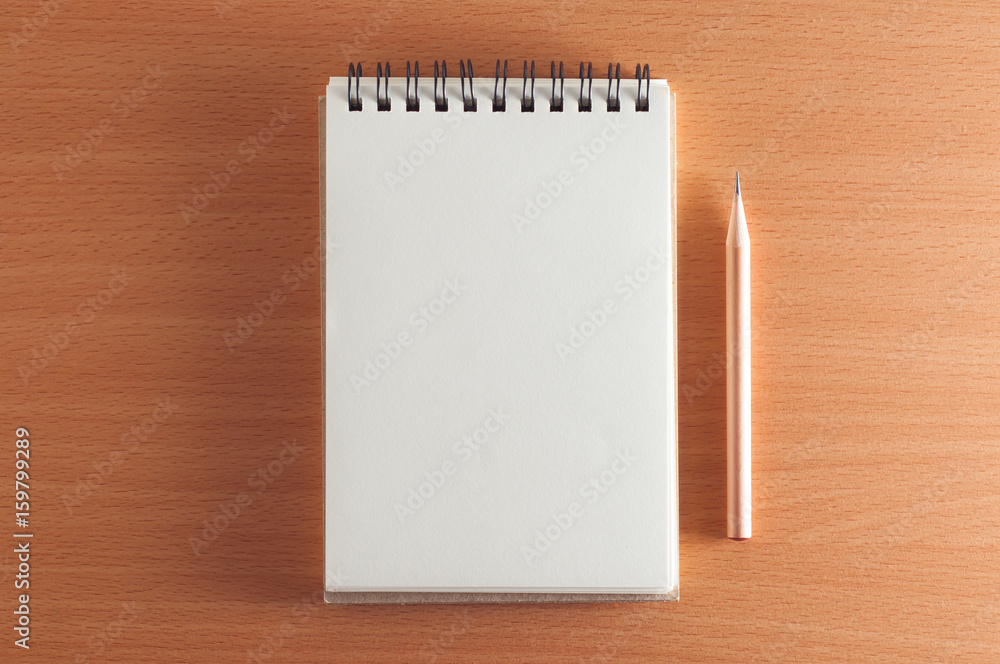 blank spiral notebook with a pencil on wooden desk blank spiral notebook with a pencil on wooden desk