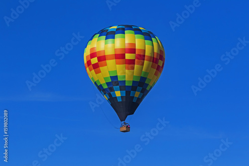 Balloon flying over California vineyard during Hot Air Balloon Festival