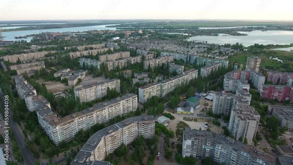 Wonderful view on Kherson multistoreyed buildings and the Dnipro river banks with a lot of greenary in the background and fine horizon line taken as aerial shot in a sunny day in summer. Wonderful view on Kherson multistoreyed buildings and the Dnipro river banks with a lot of greenary in the background and fine horizon line taken as aerial shot in a sunny day in summer.