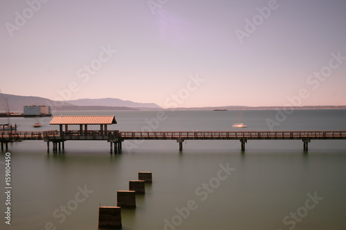 Long exposure of a long walkway over the water