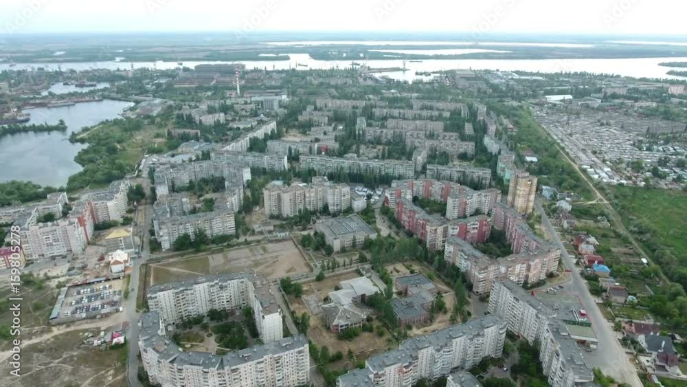 Heart breaking view on Kherson outskirts and the Dnipro river banks with a lot of greenary in the background and fine horizon line taken as aerial shot in a sunny day in summer. Heart breaking view on Kherson outskirts and the Dnipro river banks with a lot of greenary in the background and fine horizon line taken as aerial shot in a sunny day in summer.