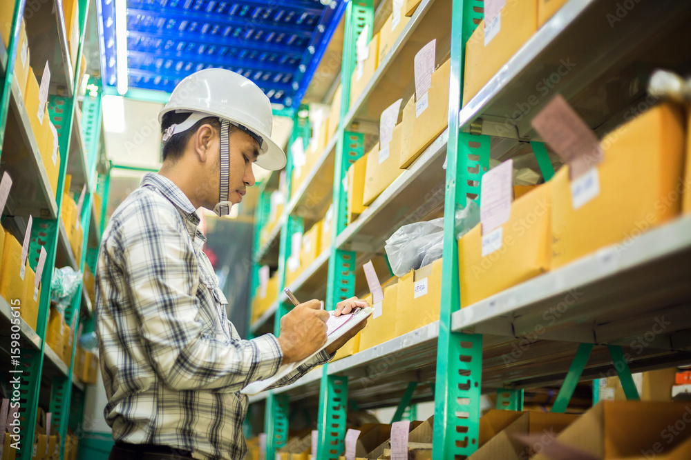 Asian man check agricultural equipment stock with smile Asian man check agricultural equipment stock with smile