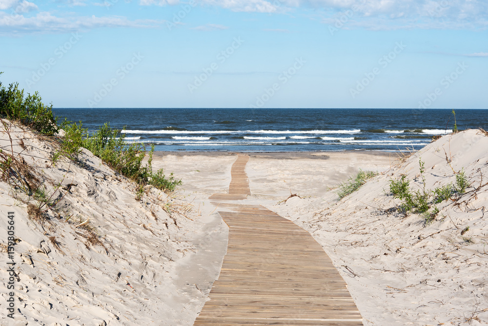 Wooden path to Baltic sea, Liepaja, Latvia. - obrazy, fototapety, plakaty 