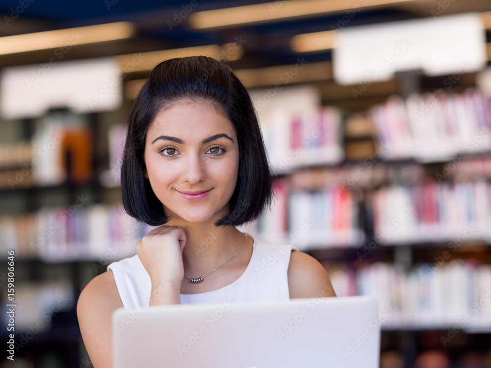Happy female student at the library Happy female student at the library