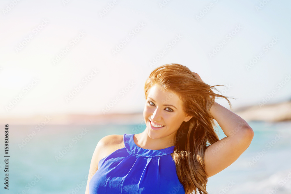 Naklejka premium Young woman walking along the beach