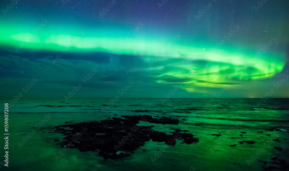Aurora borealis (northern light) over the sea, Gardur, Iceland